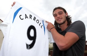 Carroll holds his No. 9 jersey aloft