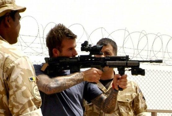 Britain's soccer player David Beckham is shown some of the weapon systems used by front line troops during a visit to Camp Bastion in Afghanistan