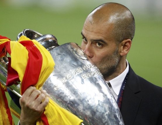 Barcelona's manager Guardiola kisses the trophy after their Champions League final soccer match victory against Manchester United in London