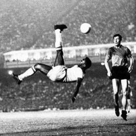 Brazilian forward Pele dribbles past a defender du