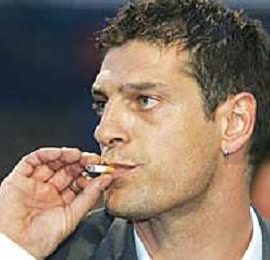Croatia coach Slaven Bilic coolly puffs away at a cigarette.