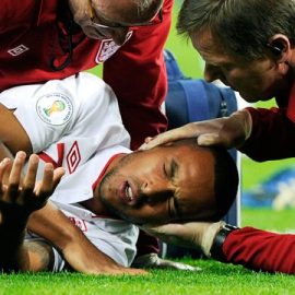 Theo Walcott being treated by England medics