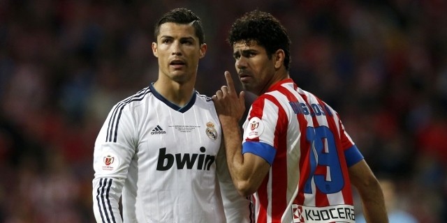Real Madrid's Cristiano Ronaldo (L) listens to Atletico de Madrid's Diego Costa during their Spanish King's Cup final soccer match at Santiago Bernabeu stadium in Madrid May 17, 2013.   REUTERS/Juan Medina (SPAIN - Tags: SPORT SOCCER) - RTXZR28