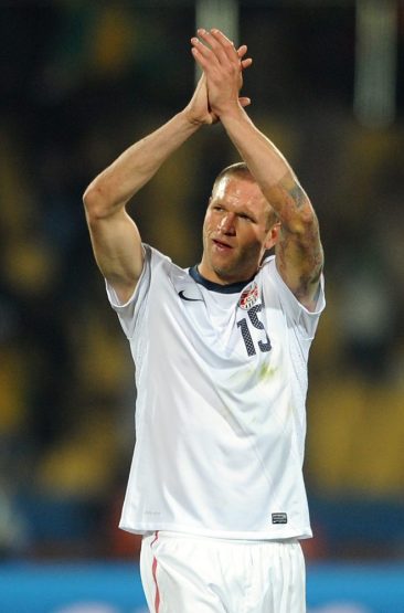 A dejected Jay DeMerit of USA applauds the supporters at full-time