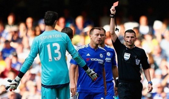 Michael Oliver shows Courtois a red card for denying Gomis a clear goalscoring opportunity