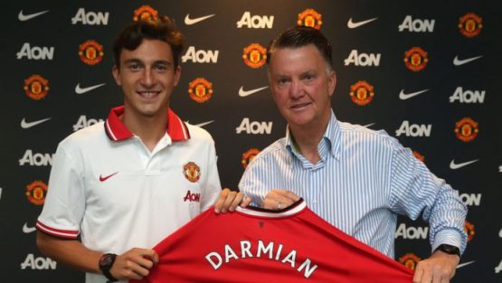 Darmian holding the Manchester United shirt with Van Gaal after completing transfer
