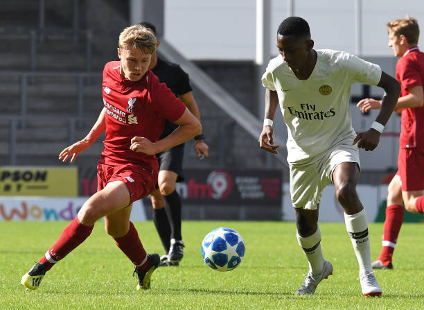 paul-glatzel-of-liverpool-and-raphael-nya-of-paris-saintgermain-in-picture-id1035656366