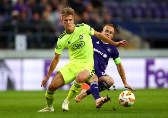 adrien-trebel-of-rsc-anderlecht-tackles-dani-olmo-of-dinamo-zagreb-picture-id1045619638