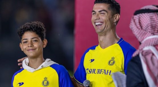 Cristiano Ronaldo and son Cristiano Ronaldo Jr wearing Al Nassr football shirts